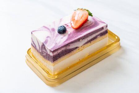 Delicious blueberry yoghurt cake on table