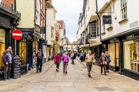 York, Yorkshire, United Kingdom - SEP 3, 2019: Stonegate street is one of the oldest streets in York with some of the half-timbered buildings. Tourists visiting and shopping in Stonegate street.のeditorial素材