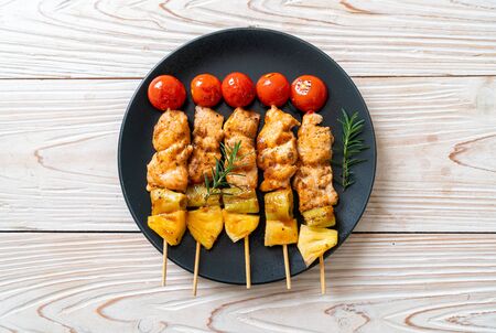 grilled chicken barbecue skewer on plateの写真素材