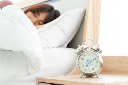 beautiful Asian women on bed and waking up in the morningの写真素材