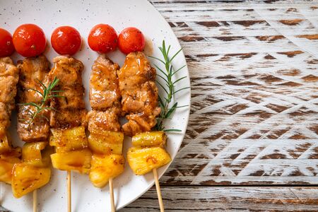 grilled pork barbecue skewer on plateの写真素材