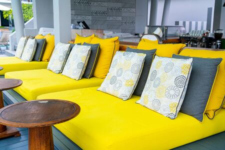 Comfortable pillows on outdoor patio chair and table in garden