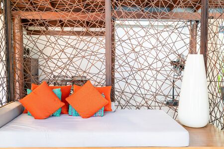 Comfortable pillows on outdoor patio chair and table in garden
