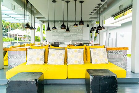 Comfortable pillows on outdoor patio chair and table in garden