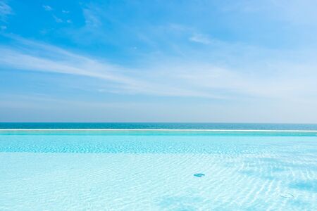 Empty swimming pool with ocean sea and blue sky