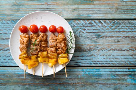 grilled pork barbecue skewer on plateの写真素材