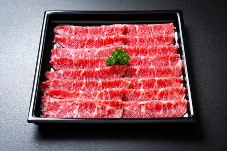 fresh beef raw sliced with marbled texture served for Sukiyaki and Shabu or Yakinikuの写真素材