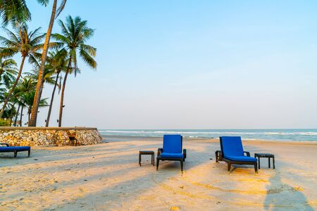 empty beach chair on beach with sea and sky backgroundの写真素材
