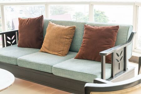 empty sofa and chair with pillows decoration in a room