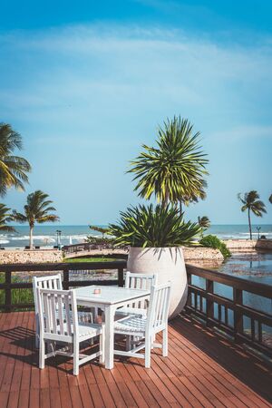 white outdoor patio chair and table with umbrellaの写真素材