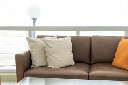 empty sofa and chair with pillows decoration in a roomの写真素材