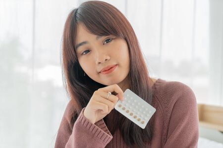 beautiful Asian women holding Birth control pillの写真素材