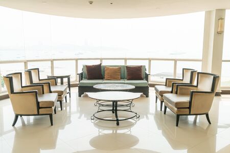 empty sofa and chair with pillows decoration in a roomの写真素材