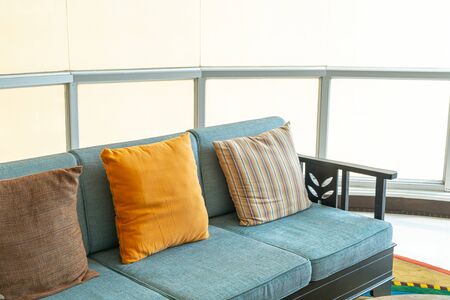 empty sofa and chair with pillows decoration in a roomの写真素材