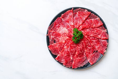 fresh beef raw sliced with marbled texture served for Sukiyaki and Shabu or Yakinikuの写真素材