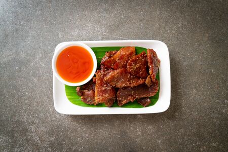 sun dried pork with sauce on plateの写真素材
