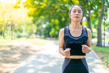 Asian woman jogging and running at parkの写真素材