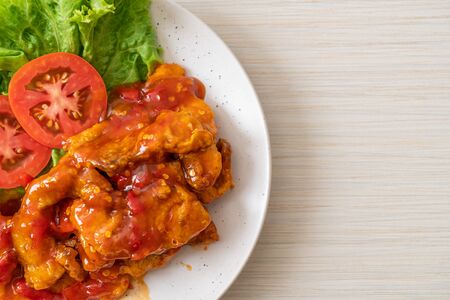 Fried fish topped with 3 flavors (sweet, sour, spicy) chili sauceの写真素材