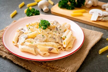 penne pasta carbonara cream sauce with mushroom - Italian food styleの写真素材