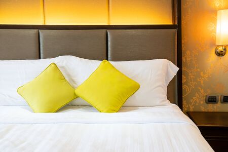 comfortable pillow decoration on bed in hotel bedroomの写真素材