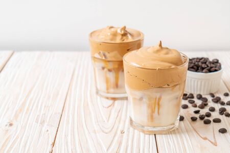 Dalgona coffee. Iced fluffy creamy whipped trend drink with coffee foam and milk. Trendy drink during Covid-19 city lock down and self quarantine, stay at home concept.の写真素材