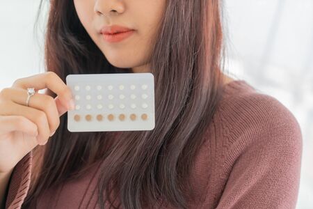 beautiful Asian women holding Birth control pill