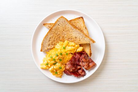 scrambled egg with bread toasted and bacon for breakfastの写真素材