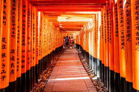 Kyoto, Japan - Jan 11, 2020 : Red Torii gates at Fushimi Inari Taisha with tourists and Japanese students. Fushimi Inari is the most important Shinto sanctuary.のeditorial素材