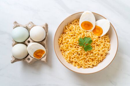 instant noodles bowl with salt eggの写真素材
