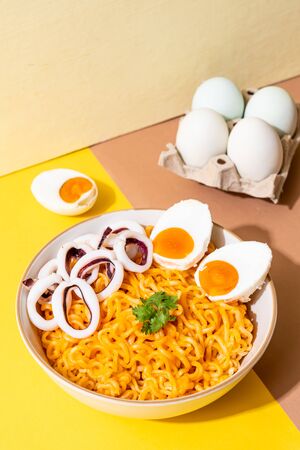 instant noodles salt egg flavour with squid or octopus bowlの写真素材