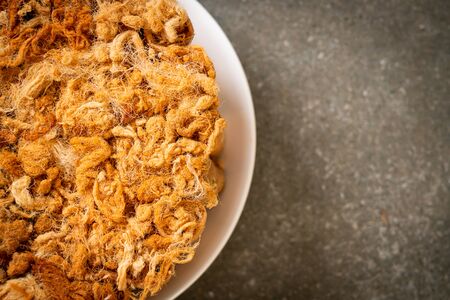 crispy coconut roll with dried shredded pork on plateの写真素材