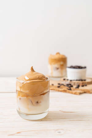 Dalgona coffee. Iced fluffy creamy whipped trend drink with coffee foam and milk. Trendy drink during Covid-19 city lock down and self quarantine, stay at home concept.の写真素材