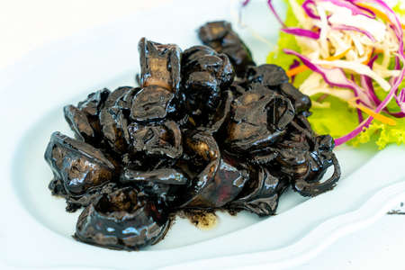 fried squid with squid ink sauce - seafood style