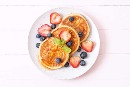 souffle pancake with fresh blueberries, fresh strawberries and honeyの写真素材