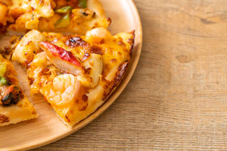 seafood (shrimps, octopus, mussel and crab) pizza on wood trayの写真素材