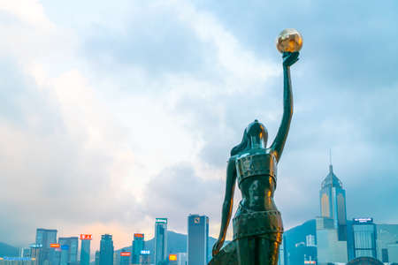 HONG KONG, CHINA - FEB 20 2019 : Statue and skyline in Avenue of Stars in Hong Kong, China. The promenade honours celebrities of the Hong Kong film industry as the famous attraction.のeditorial素材