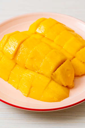 fresh and golden mango sliced on plateの写真素材