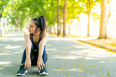 Asian woman sitting and relax after exercise at parkの写真素材