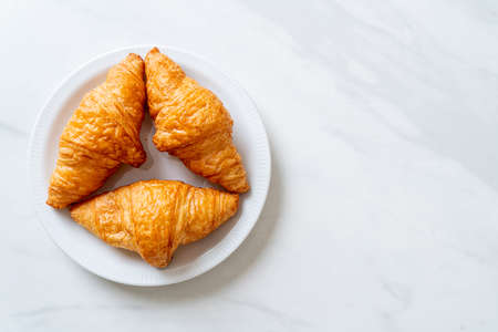 fresh butter croissant on plateの写真素材