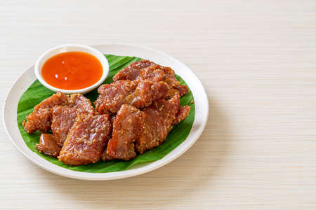 sun dried pork with sauce on plateの写真素材
