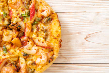 seafood (shrimps, octopus, mussel and crab) pizza on wood tray