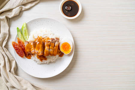 crispy belly pork on rice with barbecue red sauceの写真素材
