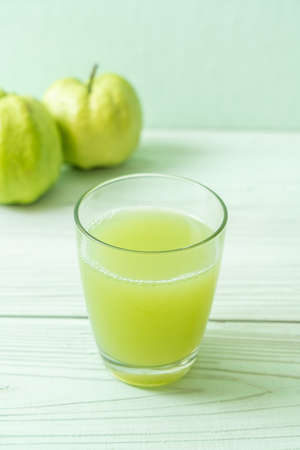 fresh guava juice glass with fresh guava fruit on wood tableの写真素材