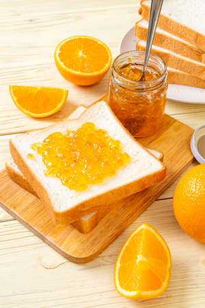 Slices of bread with orange jam for breakfastの写真素材