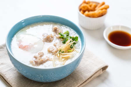 congee with minced pork in bowl - Asian breakfast styleの写真素材