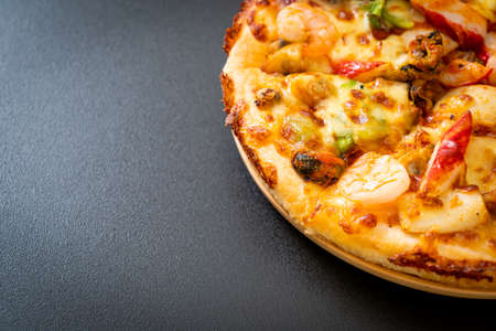 seafood (shrimps, octopus, mussel and crab) pizza on wood trayの写真素材