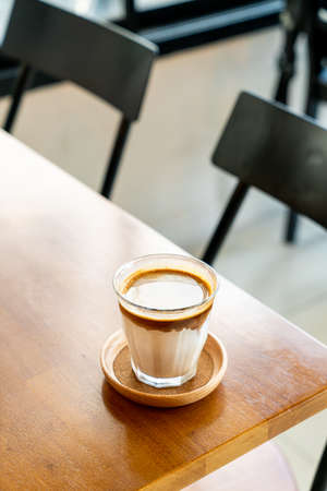 Dirty Coffee - A glass of espresso shot mixed with cold fresh milk in coffee shop cafe and restaurantの写真素材
