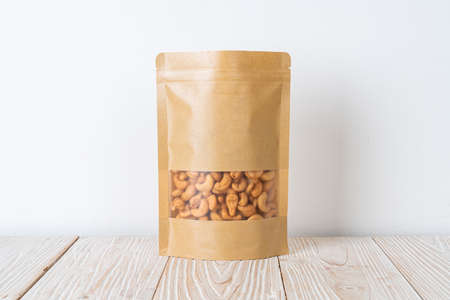 Cashew nuts in bag on wood backgroundの写真素材