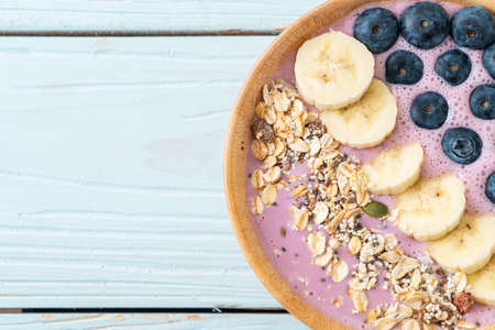yogurt or yoghurt smoothie bowl with blue berry, banana and granola - Healthy food styleの写真素材