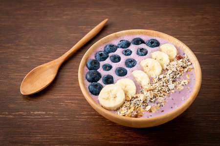 yogurt or yoghurt smoothie bowl with blue berry, banana and granola - Healthy food styleの写真素材